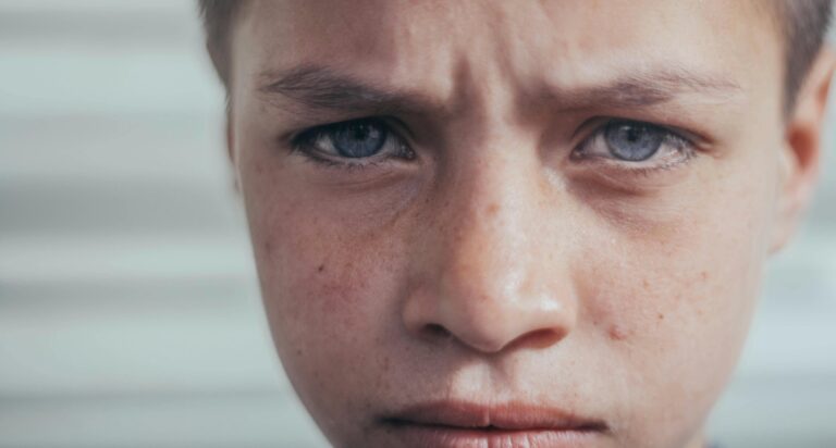 Intense close-up of a young boy's face expressing deep emotion.