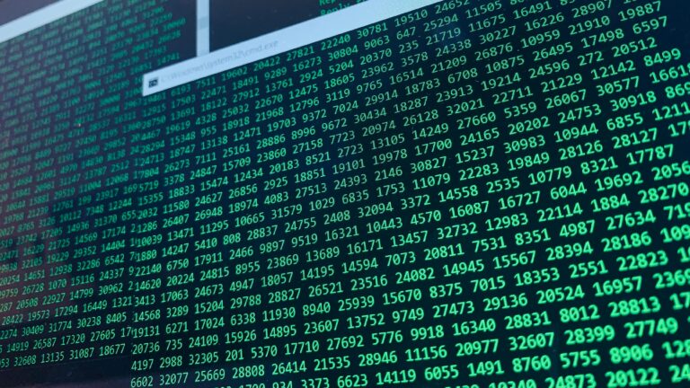Vibrant green numbers on a computer screen, showcasing binary code and data streams.