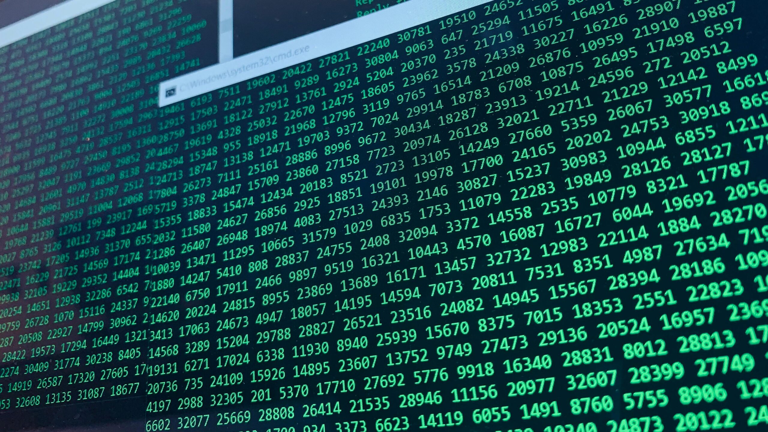 Vibrant green numbers on a computer screen, showcasing binary code and data streams.